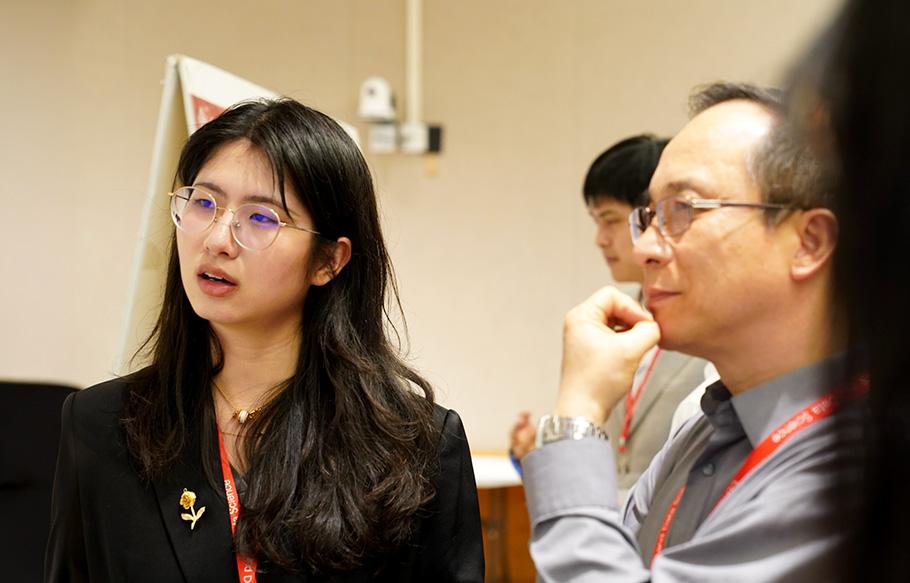 Two people listen and reflect during a research a presentation