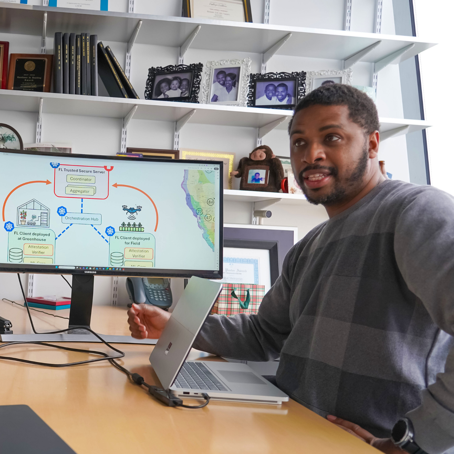 a man sits at a desk in front of a computer screen