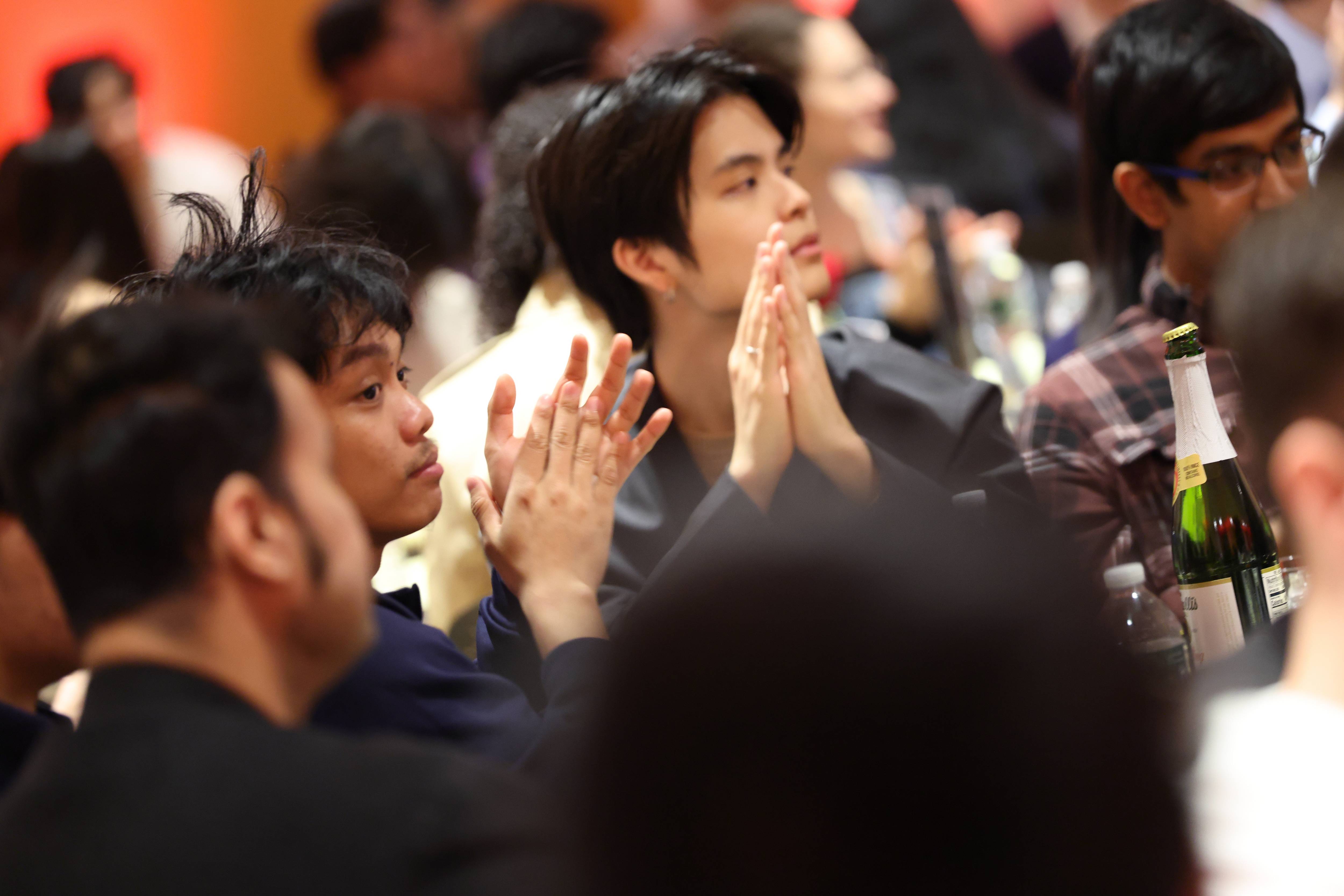 three male students clap at the Belonging at Bowers Awards